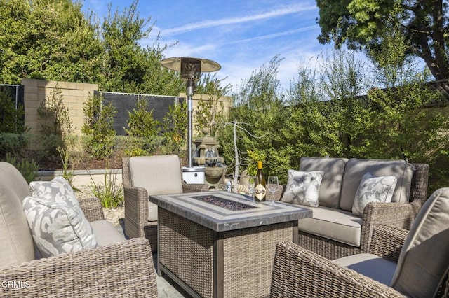 view of patio / terrace with an outdoor living space with a fire pit