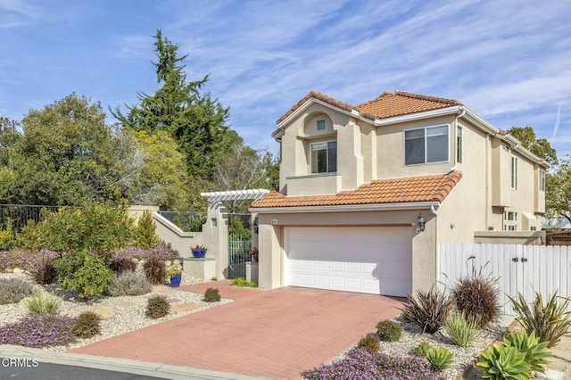 mediterranean / spanish-style home with a garage