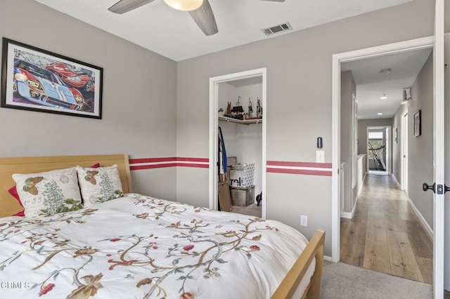 bedroom featuring a closet, ceiling fan, and carpet