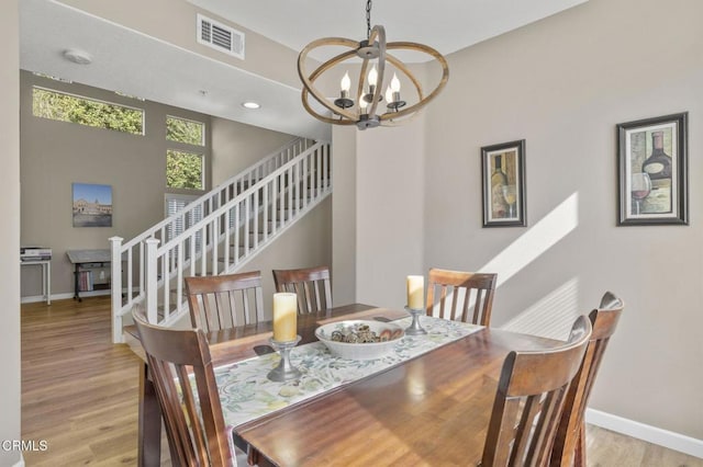 dining area featuring a notable chandelier and light hardwood / wood-style floors