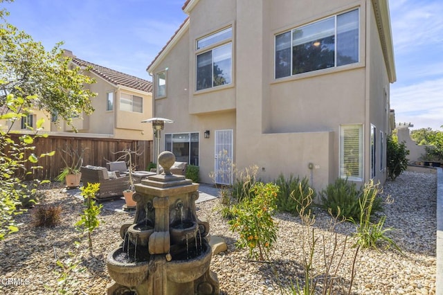 back of house featuring an outdoor living space