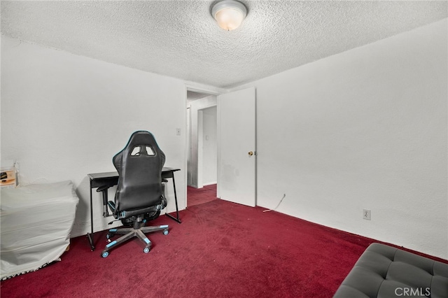 office space featuring a textured ceiling and carpet