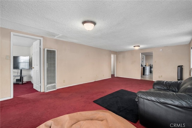 carpeted living room featuring a textured ceiling