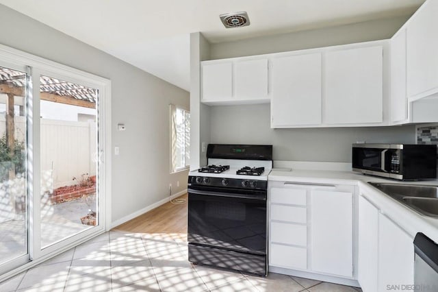 kitchen featuring stainless steel appliances, sink, and white cabinets