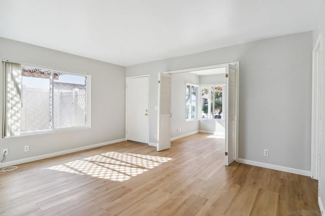 unfurnished room with light hardwood / wood-style floors