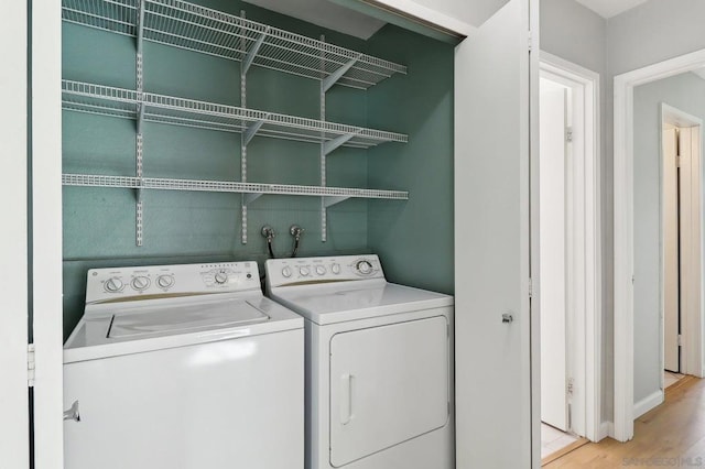 washroom featuring independent washer and dryer and light hardwood / wood-style floors