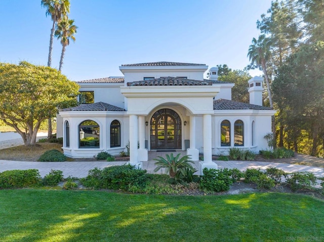 back of house featuring a yard and french doors