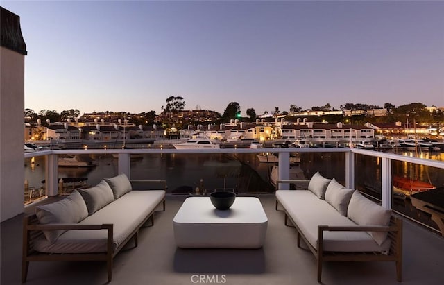 patio terrace at dusk with a balcony and an outdoor hangout area