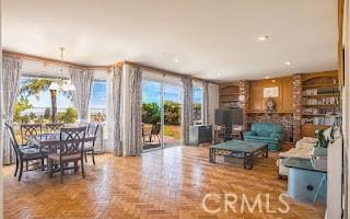 living room with parquet floors and a notable chandelier