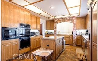 kitchen with black appliances and a kitchen island