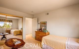 bedroom featuring light colored carpet