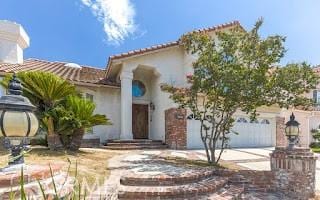 mediterranean / spanish-style home featuring a garage