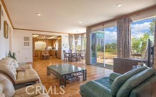 living room with hardwood / wood-style floors and ornamental molding