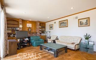 living room with crown molding and parquet flooring