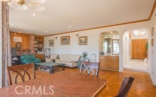 dining room featuring crown molding and parquet floors