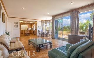 living room featuring hardwood / wood-style flooring and crown molding