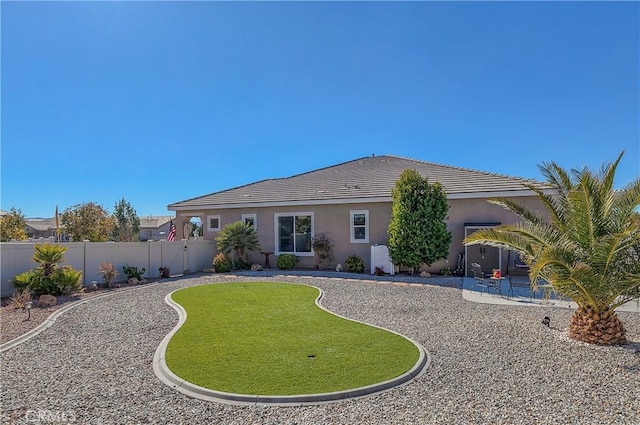 back of property with a patio