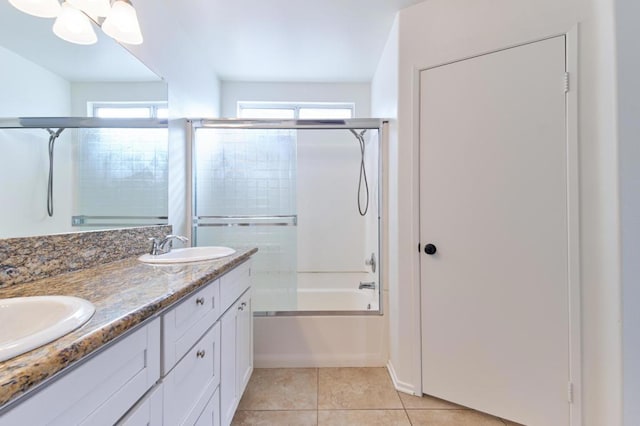 bathroom featuring vanity, tile patterned floors, and combined bath / shower with glass door