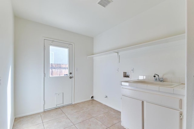 washroom featuring washer hookup, sink, electric dryer hookup, and light tile patterned flooring