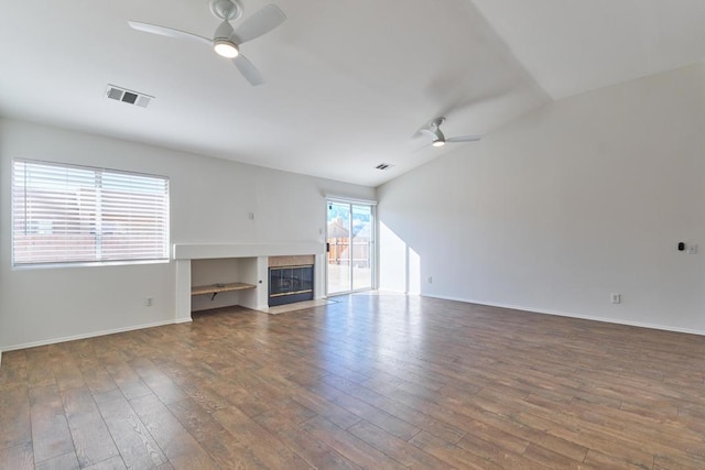 unfurnished living room with ceiling fan, dark wood-type flooring, and a fireplace