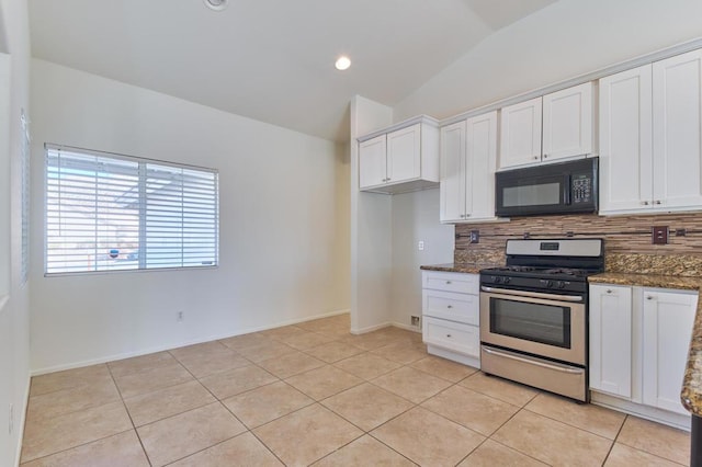 kitchen featuring vaulted ceiling, dark stone counters, gas stove, and white cabinets