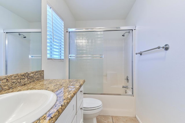 full bathroom featuring shower / bath combination with glass door, tile patterned floors, toilet, and vanity