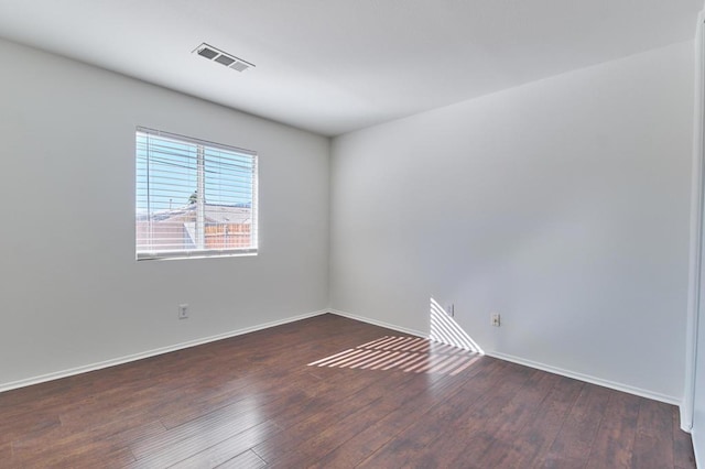 spare room with dark hardwood / wood-style flooring