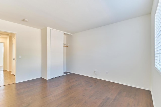 unfurnished room with dark hardwood / wood-style floors