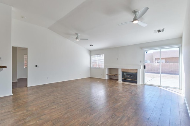 unfurnished living room featuring dark wood-type flooring, ceiling fan, and vaulted ceiling