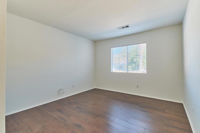 empty room with dark hardwood / wood-style floors