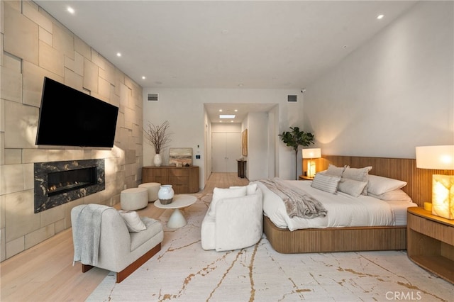 4727 Alonzo Ave, Encino, CA 91316 - bedroom with a tiled fireplace and light wood-type flooring