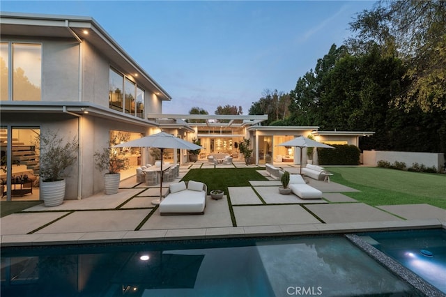 4727 Alonzo Ave, Encino, CA 91316 - back house at dusk featuring a patio, outdoor lounge area, a yard, and a pergola