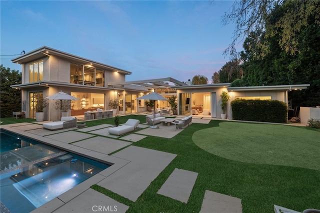 4727 Alonzo Ave, Encino, CA 91316 - back house at dusk with an outdoor living space and a patio area