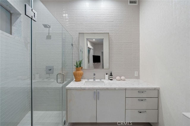 4727 Alonzo Ave, Encino, CA 91316 - bathroom with vanity, a shower with door, and tile walls