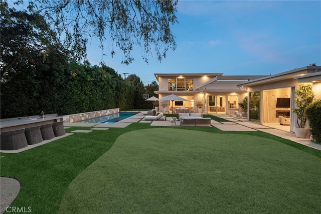 4727 Alonzo Ave, Encino, CA 91316 - back house at dusk with a patio area and outdoor lounge area