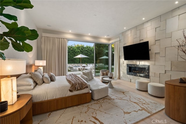 4727 Alonzo Ave, Encino, CA 91316 - bedroom featuring a fireplace, light hardwood / wood-style flooring, and access to outside