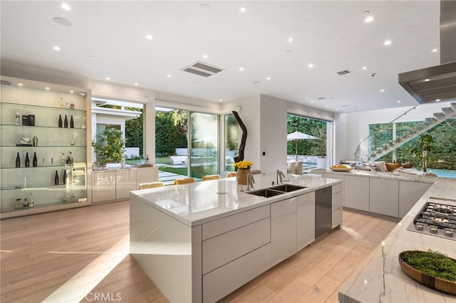 4727 Alonzo Ave, Encino, CA 91316 - kitchen with sink, light stone counters, island exhaust hood, a large island, and white cabinets