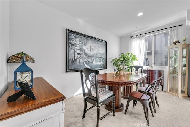 dining area featuring light carpet