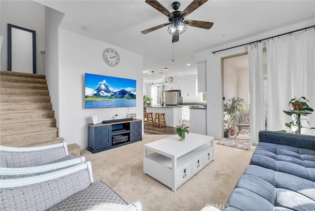 living room with ceiling fan and light carpet