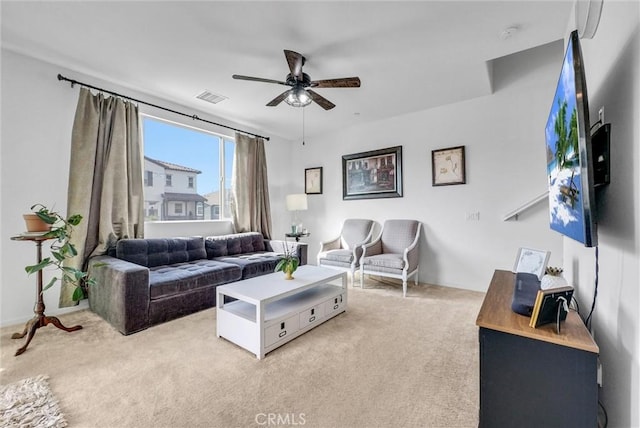 carpeted living room featuring ceiling fan