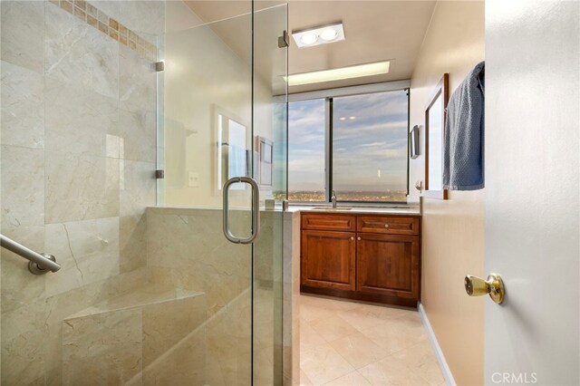 bathroom featuring sink, an enclosed shower, and tile patterned floors