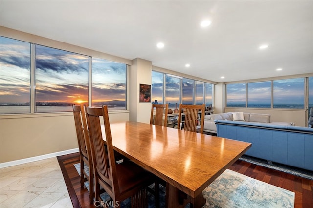 dining room with recessed lighting and baseboards