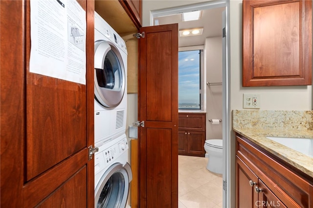 washroom with laundry area and stacked washer / dryer