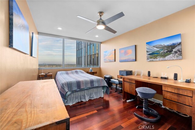 bedroom with ceiling fan and dark hardwood / wood-style flooring