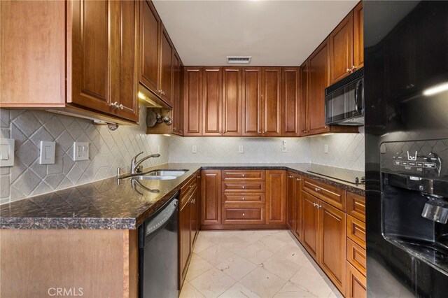 kitchen with backsplash, dark stone countertops, sink, and black appliances