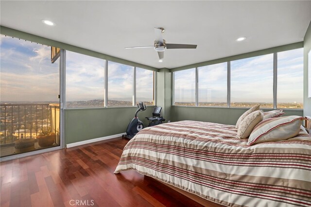 bedroom with ceiling fan and dark hardwood / wood-style floors