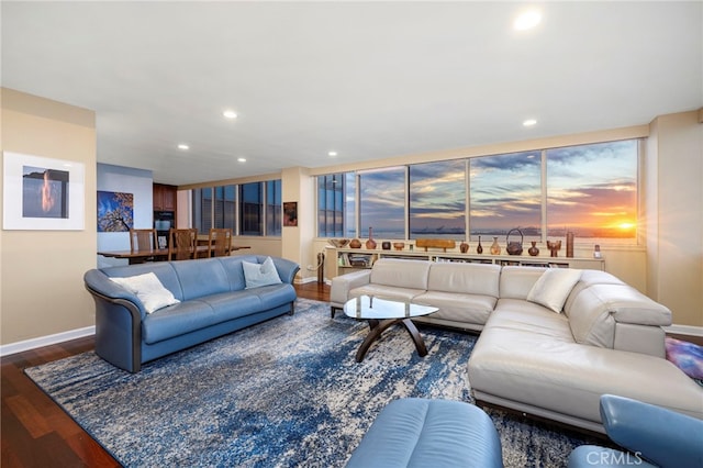 living area with recessed lighting, wood finished floors, and baseboards