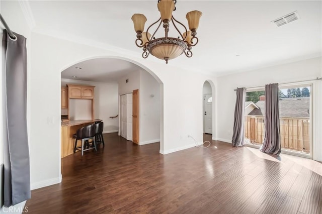 interior space with a chandelier and dark hardwood / wood-style flooring