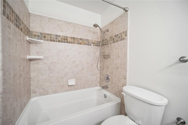 bathroom featuring tiled shower / bath and toilet