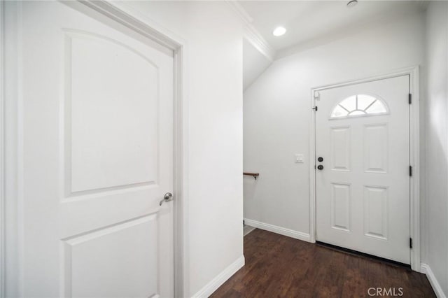 entryway with crown molding and dark wood-type flooring